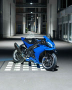 Blue motorcycle parked in a modern indoor setting with geometric floor design