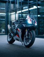 Black motorcycle with red accents parked indoors