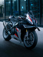 Black motorcycle with red and white accents parked indoors.