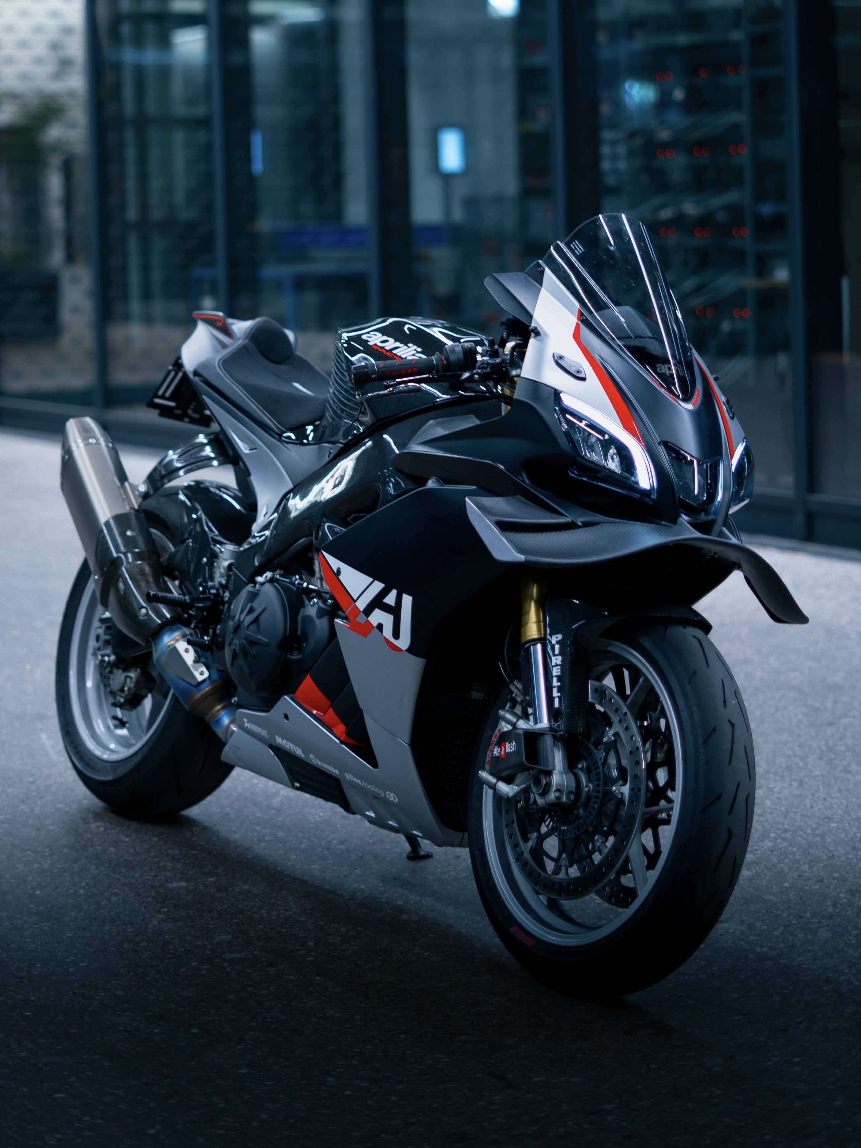 Black motorcycle with red and white accents parked indoors.